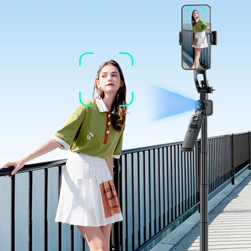 A woman on a bridge filmed by a phone on the face-tracking tripod, which turns to keep her in frame